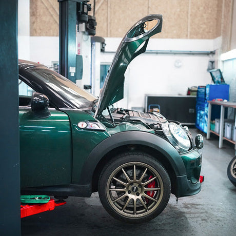 Mini coupe R58 on the ramp for a de-coke service