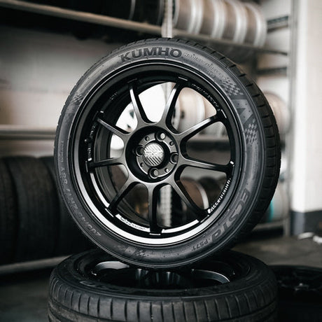 a stack of Black OZ Racing wheels with Kumho tires. Top one displayed standing up