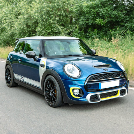 A customised blue F56 Gen 3 MINI Cooper S driving in the countryside